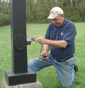 Guy testing power at an electrical pole